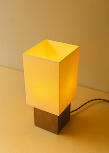 table lamp with a satin nickel base on a beige surface